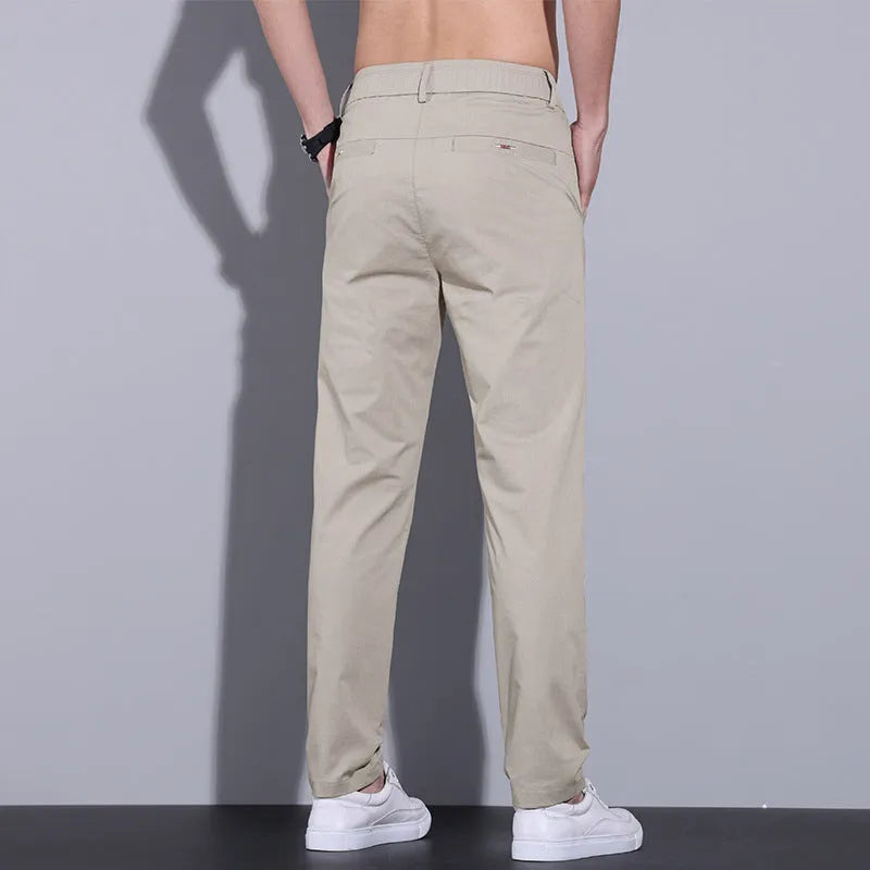 Men's straight-cut slim-fit casual trousers in light khaki cotton fabric for spring summer wear.