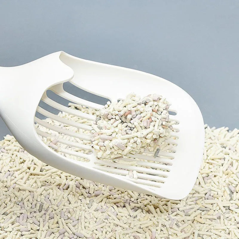Large white plastic cat litter shovel with angled handle on a grey background.
