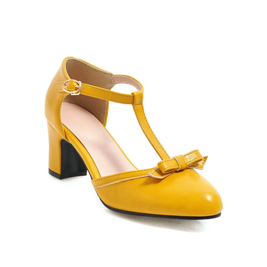 Yellow women's chunky heel sandals with a buckle strap and bow detail on a solid colour PU upper.