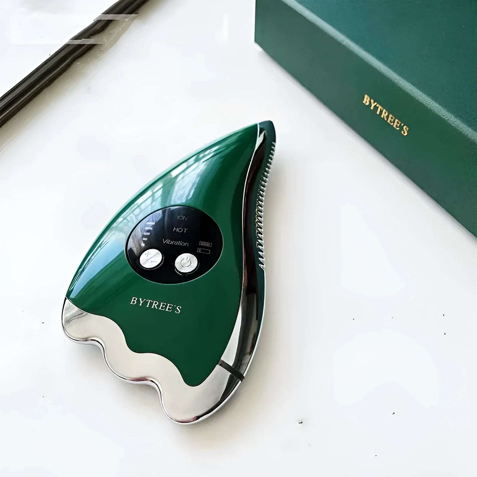 Green facial beauty instrument with plastic and metal body and USB cable