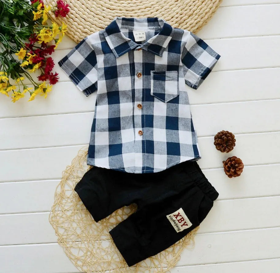 Baby boy wearing a blue cotton short sleeve t-shirt and matching shorts summer outfit