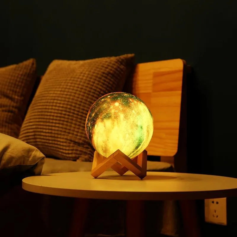 3D printed spherical lunar lamp with colour changing LED light on a surface.