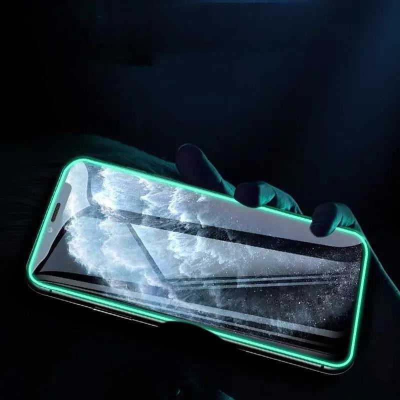 Luminous full cover tempered glass screen protector for iPhone glowing in dark on a phone.