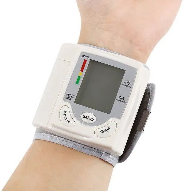 Grey wrist blood pressure monitor with compact rectangular design and display screen