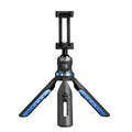 Black desktop tripod holding an iPhone, made from aluminium alloy and plastic, on a wooden table.