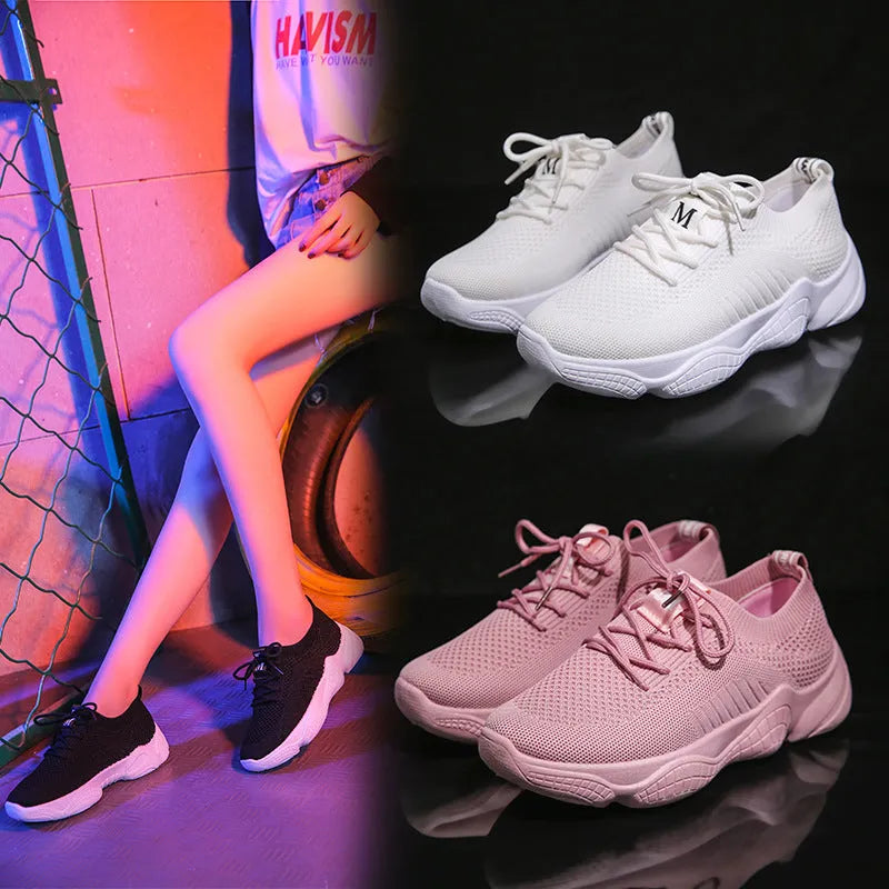 Women's white low-top sports shoes with a woven upper and thick rubber sole.