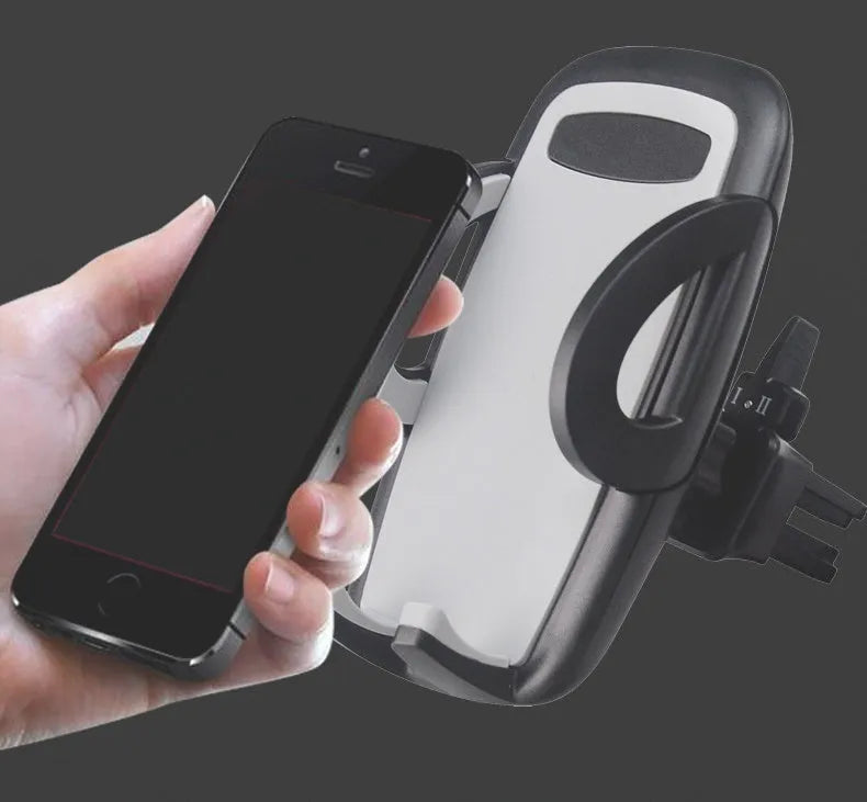 Black plastic car phone holder mounted on air conditioning vent holding smartphone