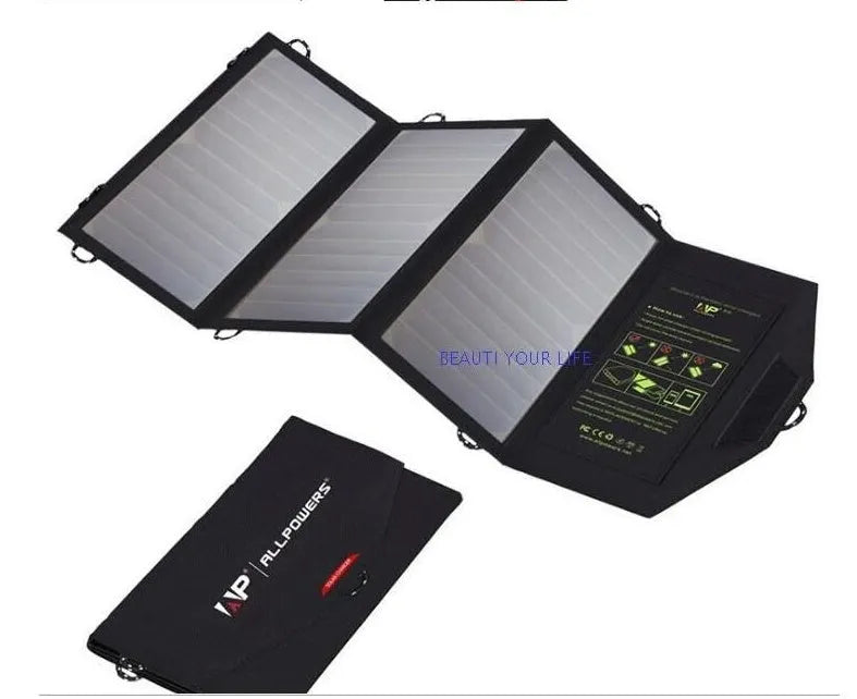 Black foldable solar panel charger with dual USB ports, shown unfolded with mounting loops
