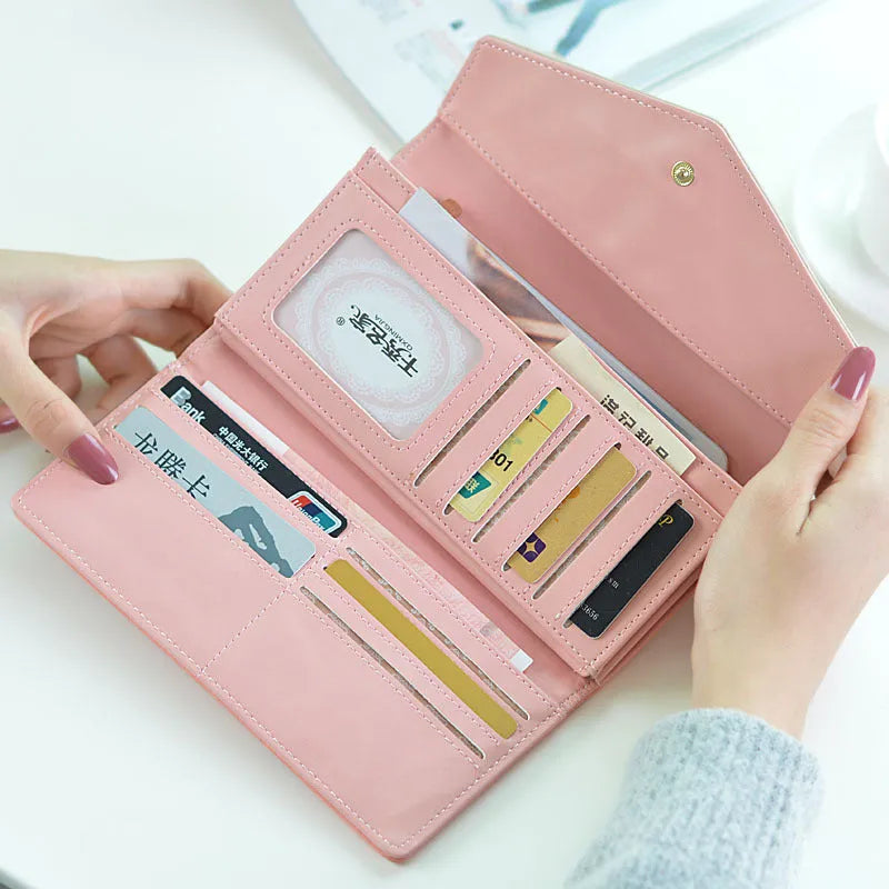 PU leather three-fold clip wallet with buckle closure in multiple colours showing interior compartments.