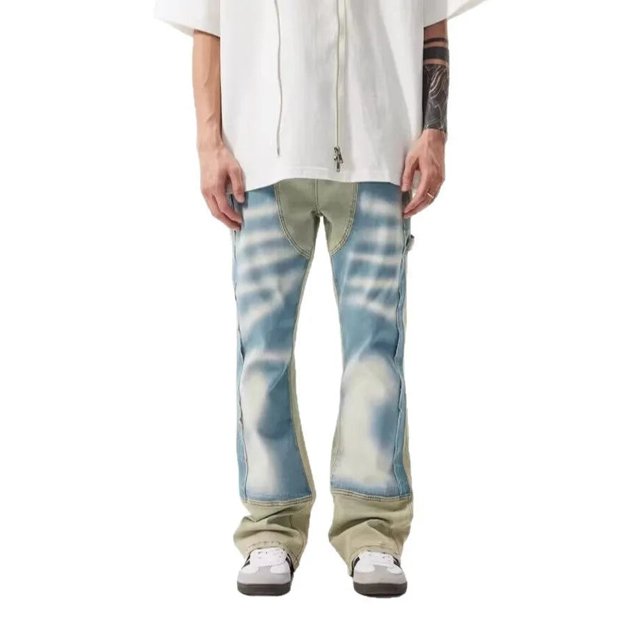 Yellow and blue retro patchwork jeans with splash-ink damaged design and zip fly.