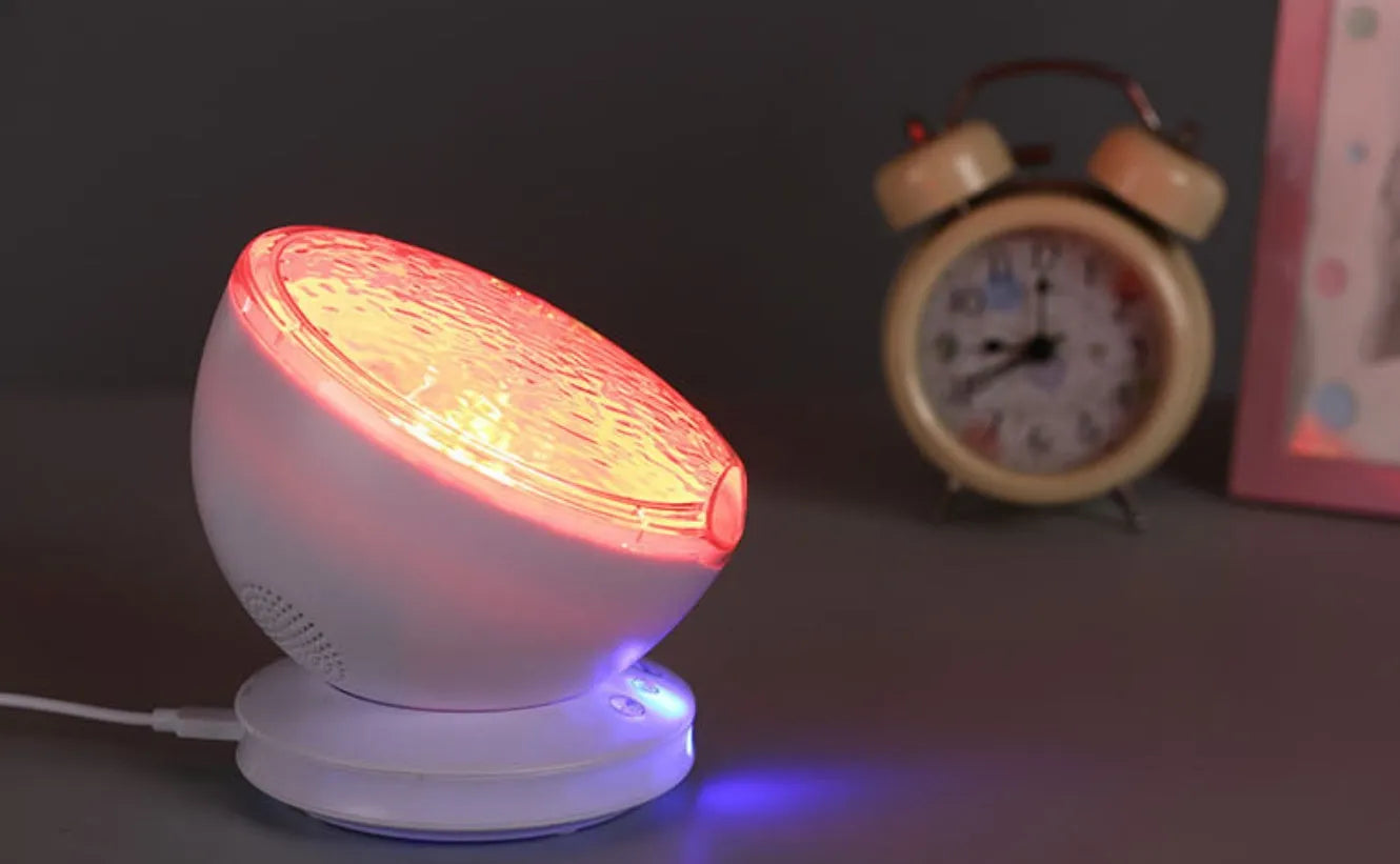 White and blue ocean wave projector LED night light with remote control, measuring 13x12x12 cm