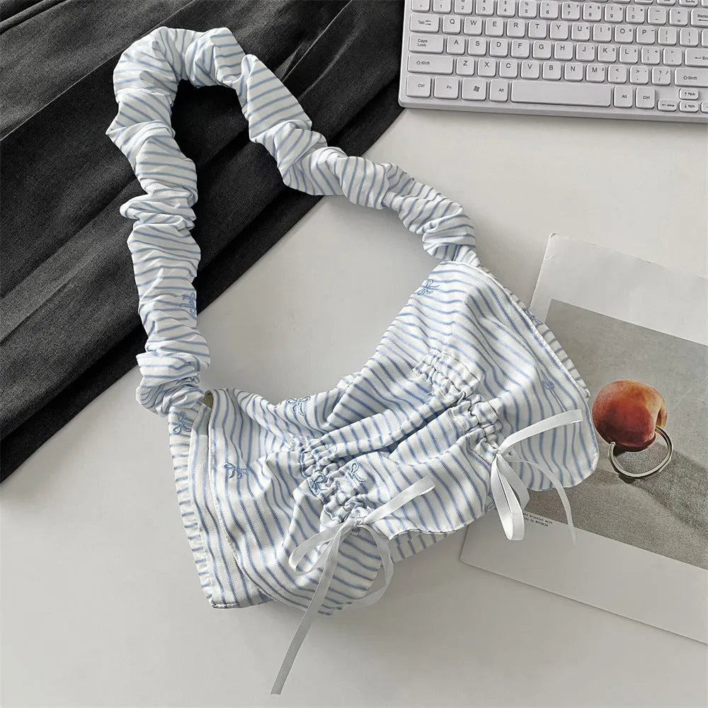 Women's polyester pleated shoulder bag with blue plaid pattern and blue bow detail, clamshell opening