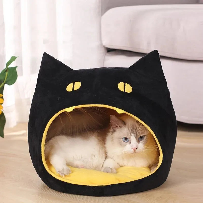 Enclosed cat-shaped pet bed with plush fabric and covered cave design