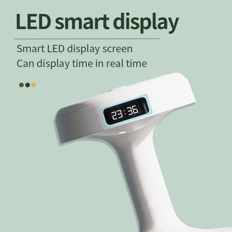 White columnar anti-gravity humidifier with LED clock display emitting mist on a wooden desk.