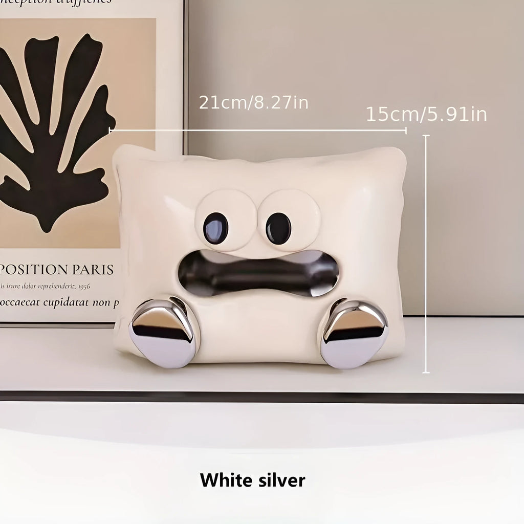 White ceramic tissue box holder on a wooden table.