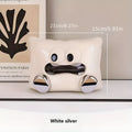 White ceramic tissue box holder on a wooden table.