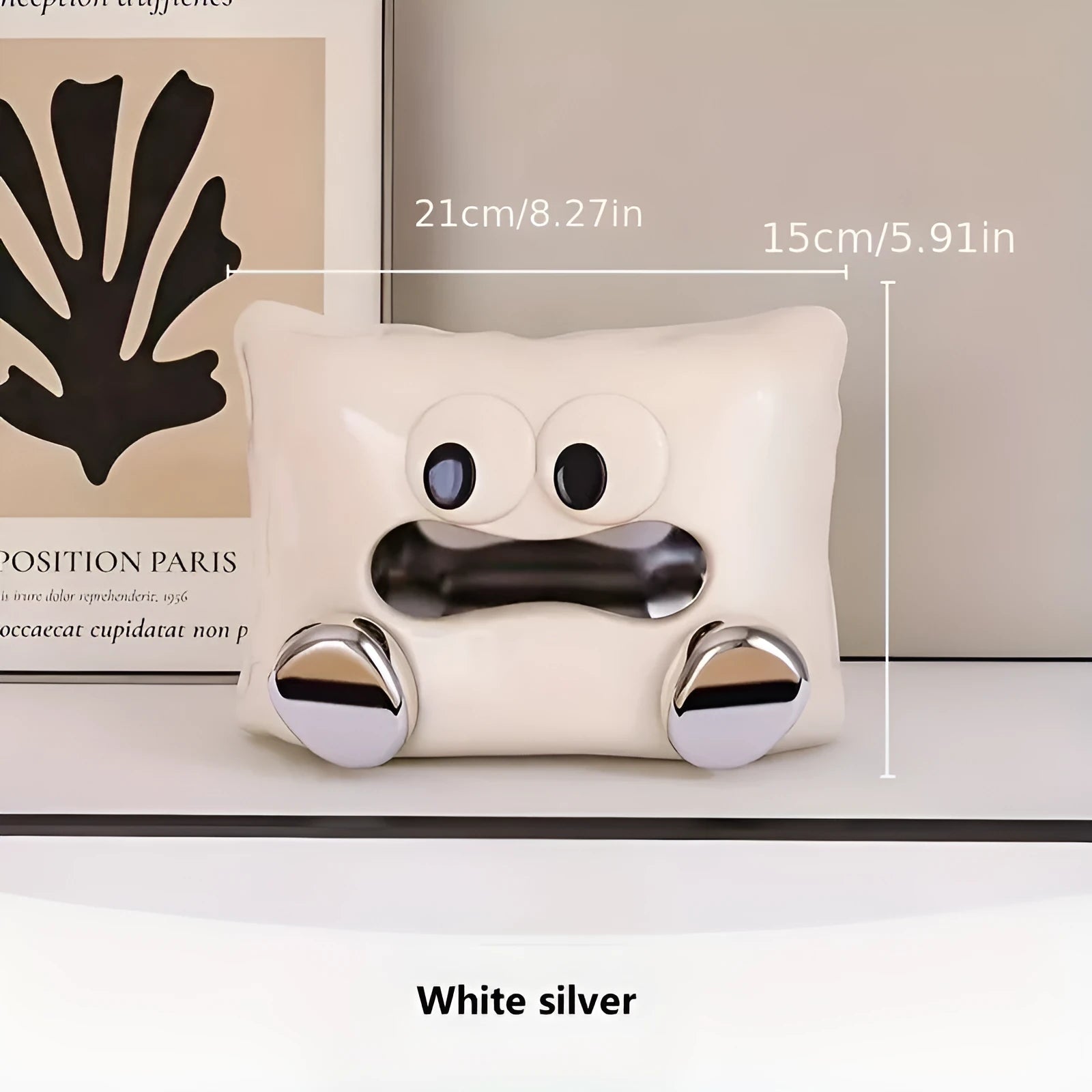 White ceramic tissue box holder on a wooden table.