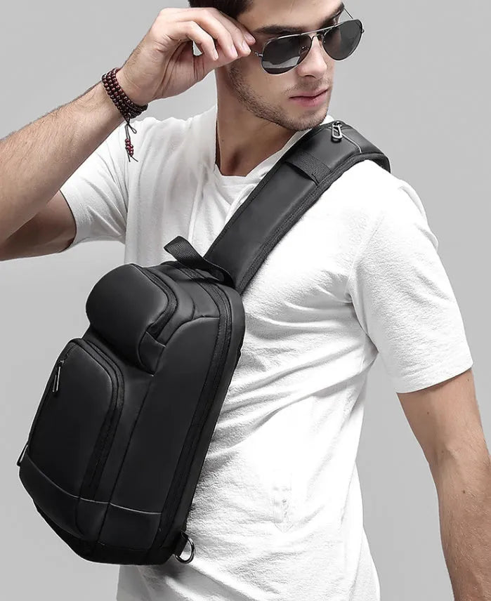 Black PVC outdoor shoulder bag showing internal laptop pocket and air cushion shoulder strap.