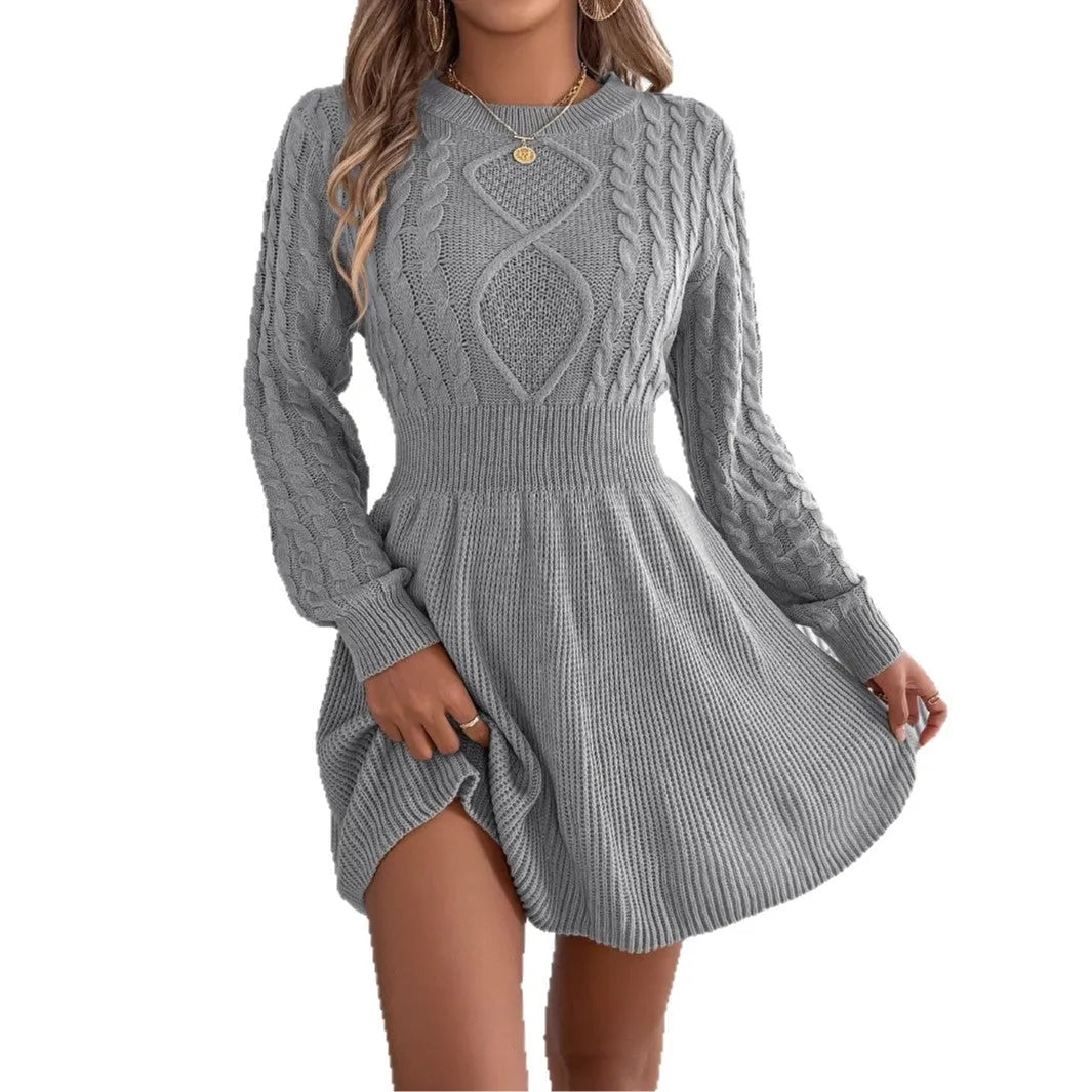 Woman wearing a black lantern sleeve sweater dress with an elastic fitted waist.