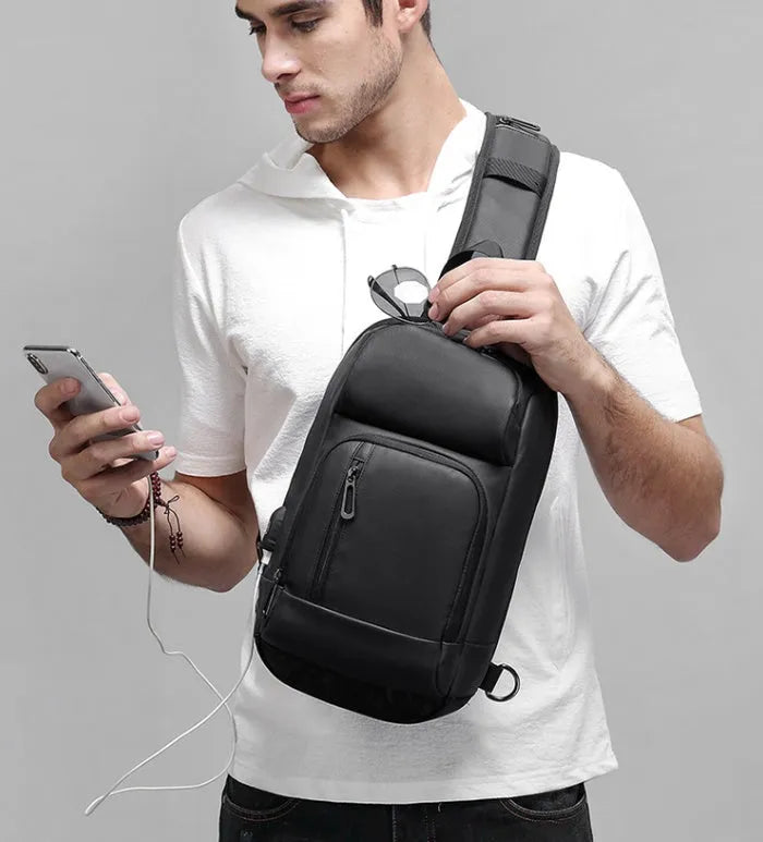 Black PVC outdoor shoulder bag showing internal laptop pocket and air cushion shoulder strap.
