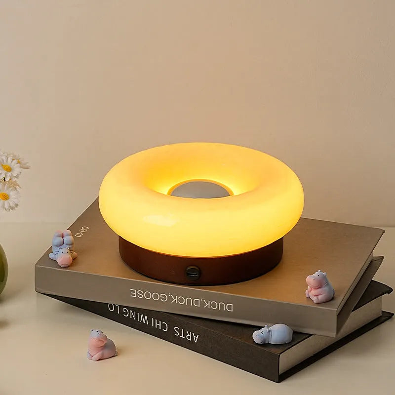 Donut-shaped rechargeable touch table lamp in custard colour with three colour temperature settings