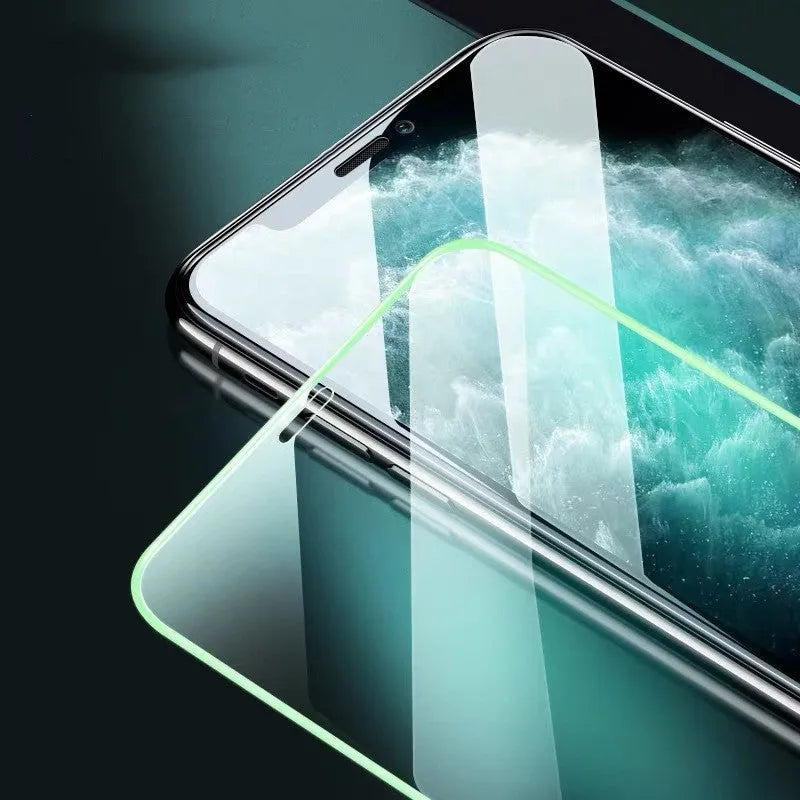 Luminous full cover tempered glass screen protector for iPhone glowing in dark on a phone.