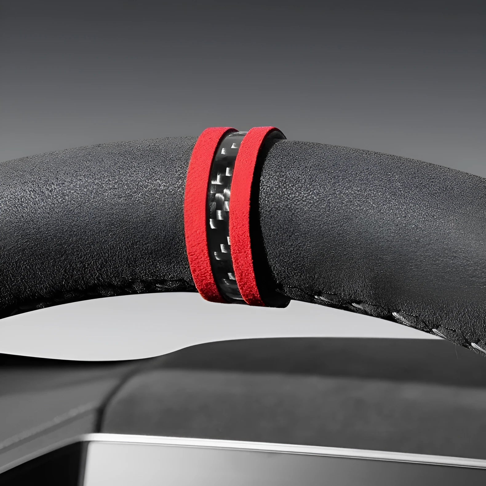 Suede and carbon fibre steering wheel cover in multiple colour options on a car steering wheel.