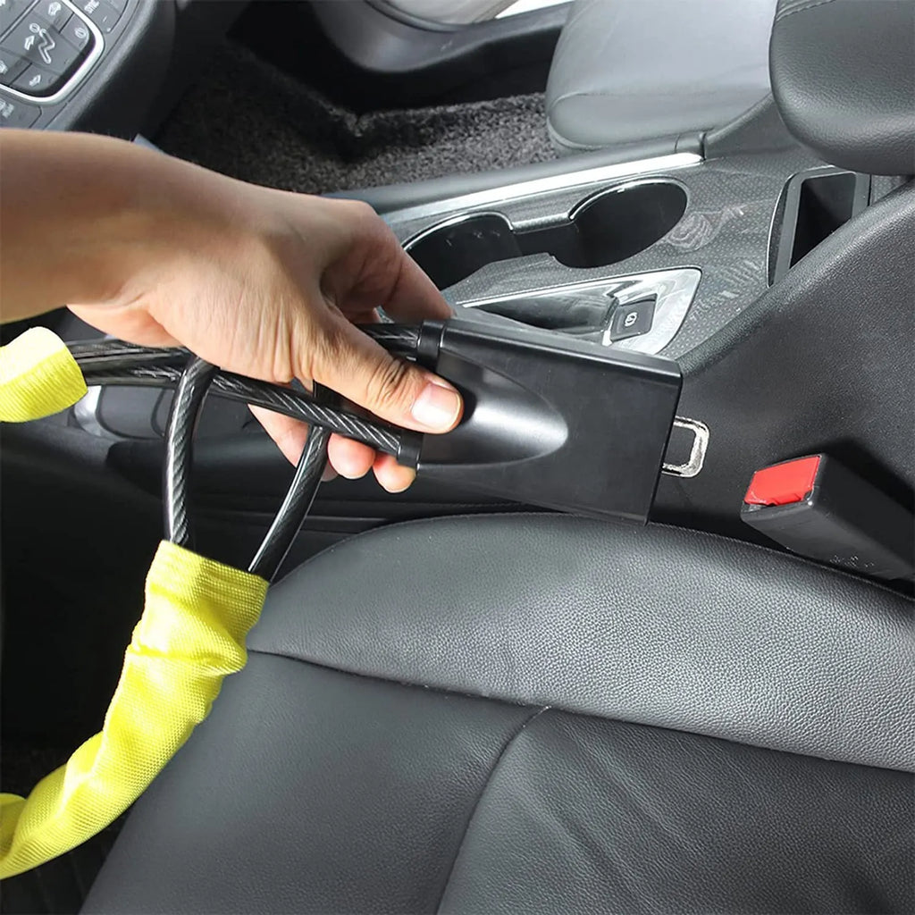 Red iron car steering wheel lock with wire rope, shown on a GM vehicle steering wheel.