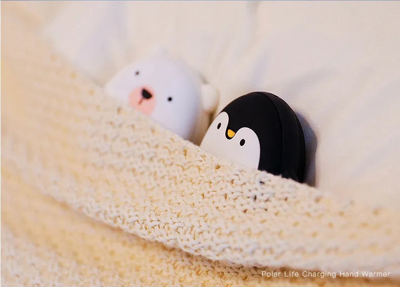 Cartoon penguin and polar bear USB rechargeable electric hand warmers showing dual-sided heating design