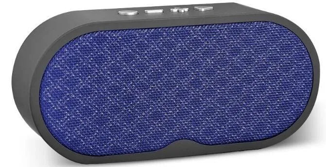 Grey portable Bluetooth speaker with subwoofer, HD microphone, TF card slot and USB port on a table.