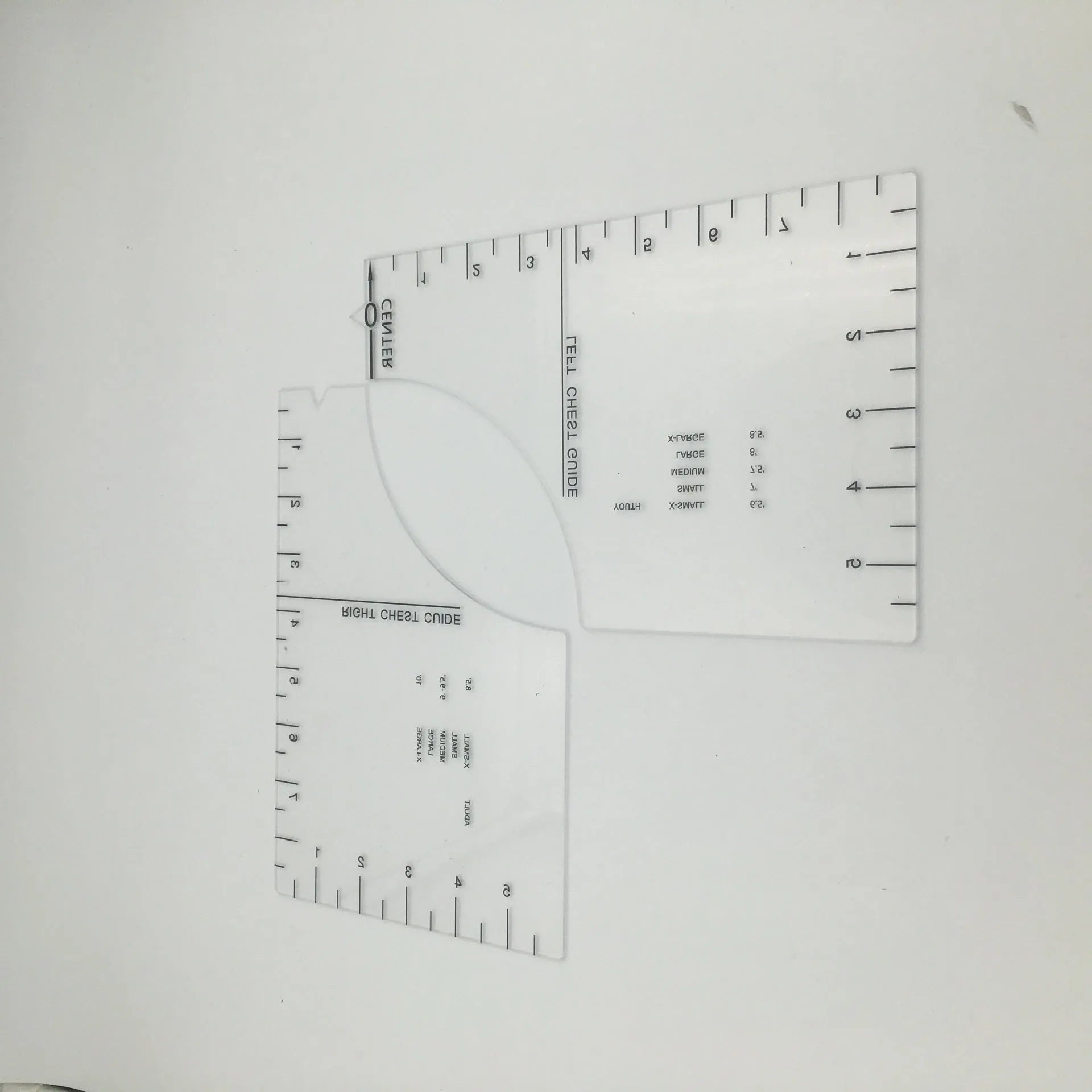 Transparent acrylic sewing ruler template for T-shirt patch alignment showing etched measurement markings
