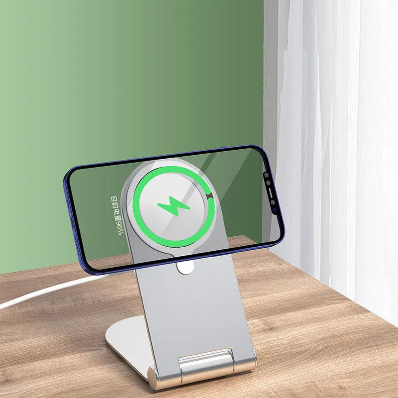 Silver portable magnetic phone bracket for iPhone 12 shown on a car dashboard.