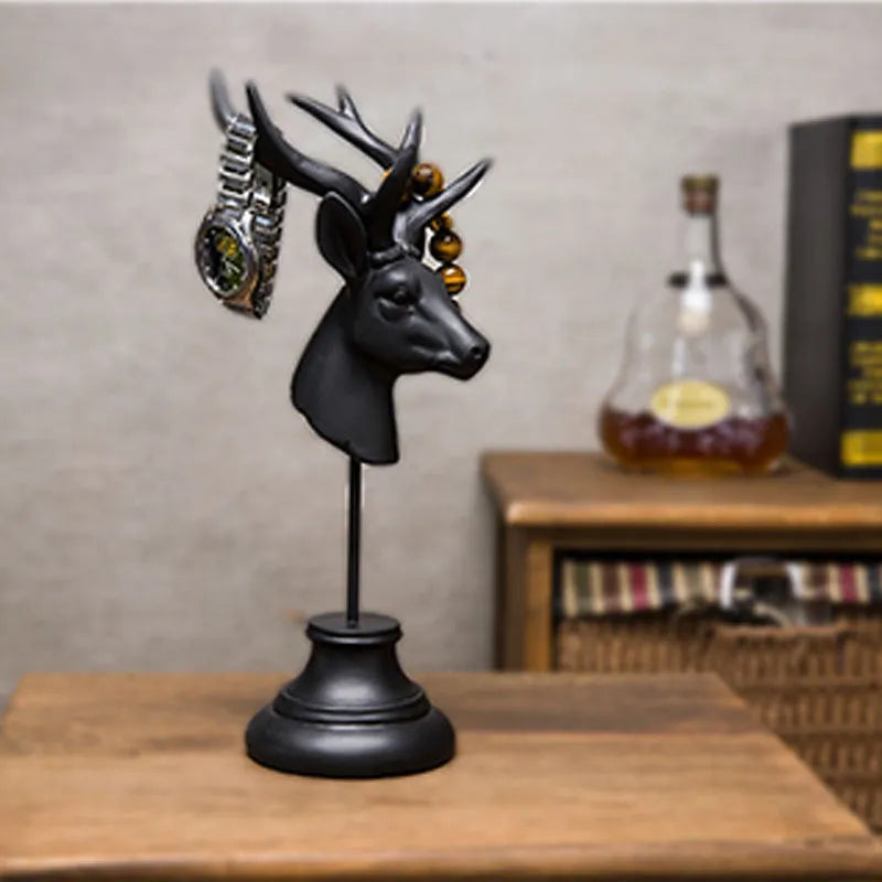Natural resin animal sculpture home decoration in black, white, or wood colour on a wooden surface.