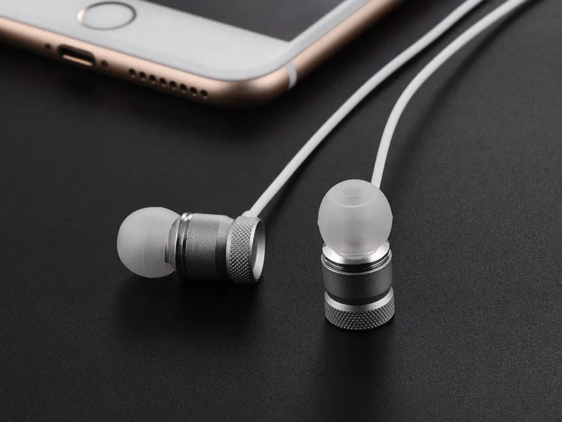 Close-up of TPE in-ear headphones in silver colour, showing the 10mm speaker driver grille.