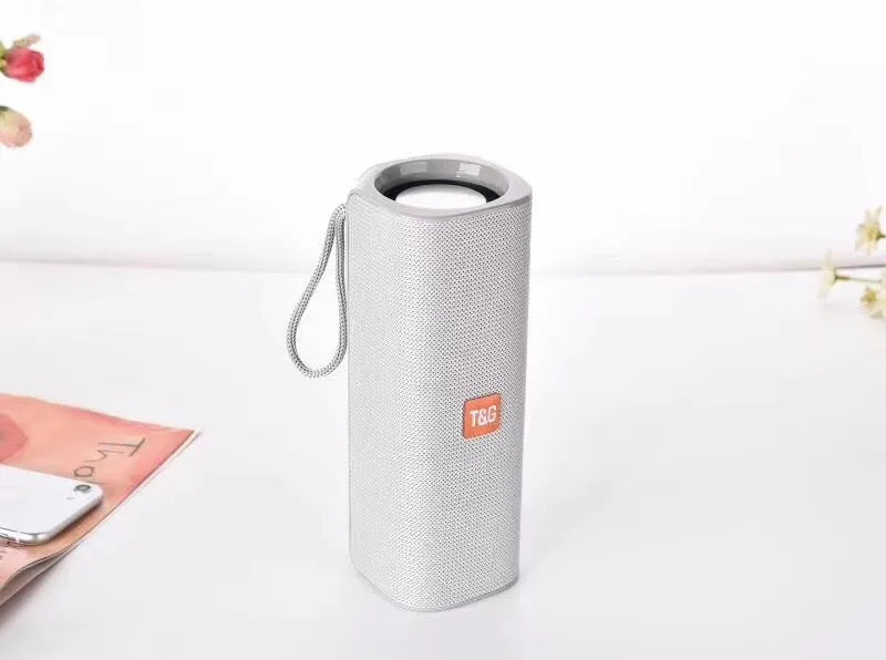 Fabric-covered portable Bluetooth speaker with USB port and control buttons