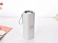 Fabric-covered portable Bluetooth speaker with USB port and control buttons