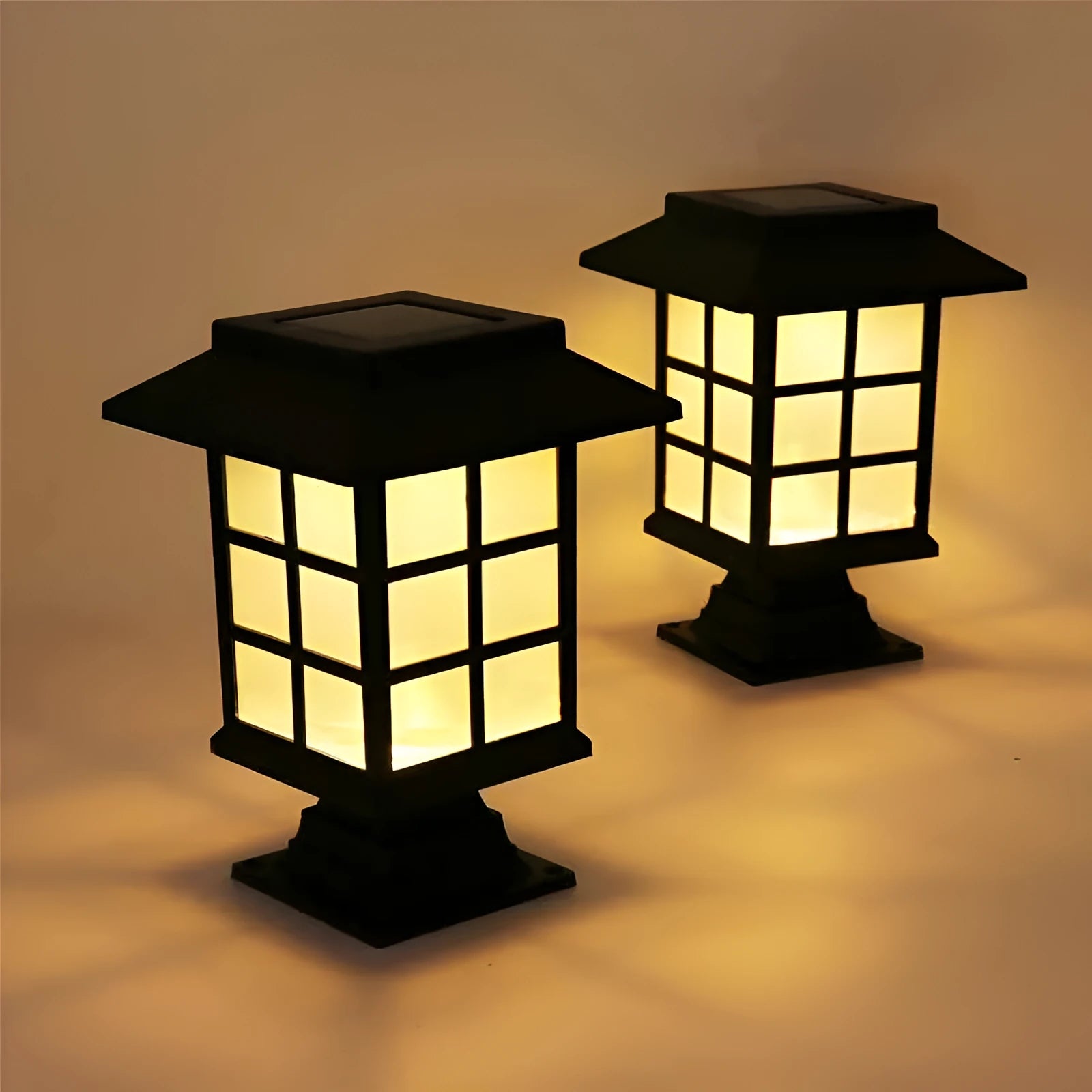 Black solar outdoor LED lawn light with window-style apertures emitting soft white or warm white light
