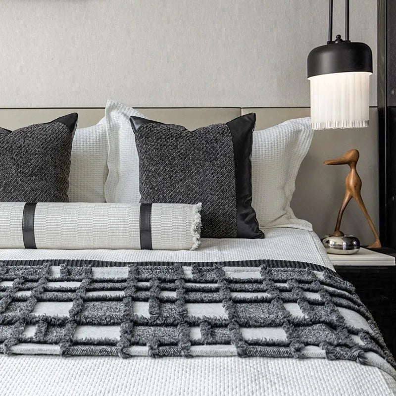 Modern minimalist grey and white plaid bed runner blanket set with pillow on a double bed.