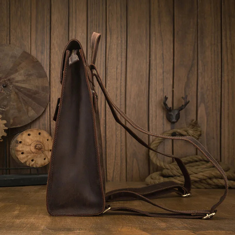 Dark brown genuine leather men's travel bag with shoulder straps and vertical square shape