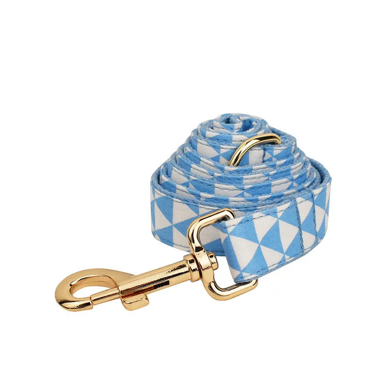 Blue cloth dog collar, leash, vest, and bow set with triangular ring rope design on a white background.