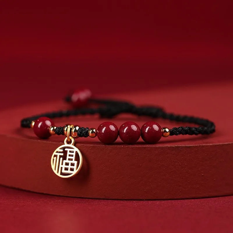 Cinnabar braided rope bracelet with blessing card, shown in black, red, or wine red with round bead or flower charm.