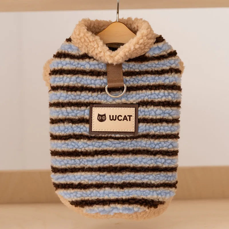 Blue striped lambskin fleece dog coat with drawstring and leash ring on a small dog against a neutral background