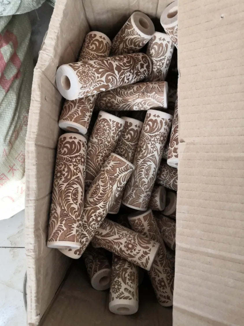 Wooden rolling pin with embossed Christmas patterns including reindeer and snowflakes on a 45cm length.
