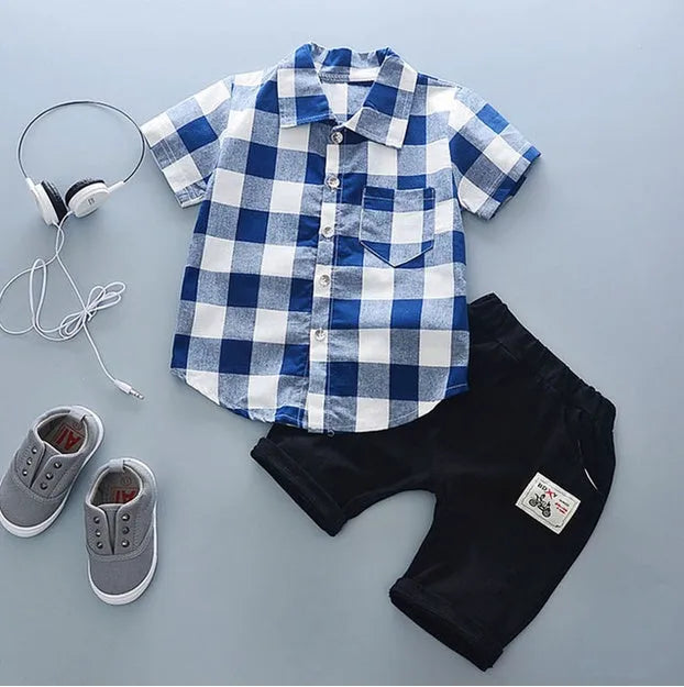 Baby boy wearing a blue cotton short sleeve t-shirt and matching shorts summer outfit