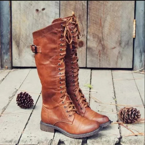 Women's black chunky heel high-leg boots with a round toe and low rubber sole.