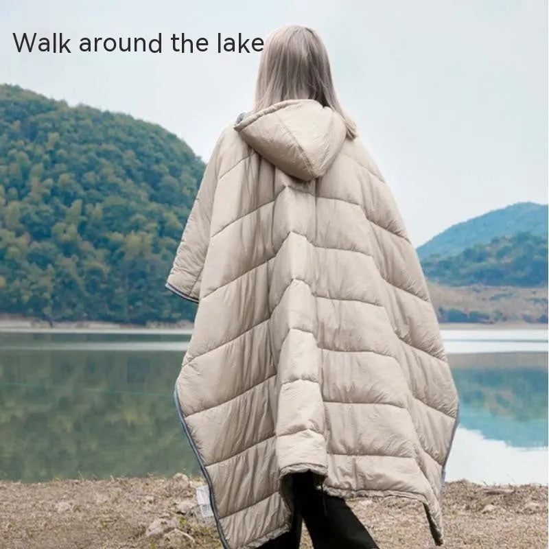 Outdoor wearable cloak sleeping bag in army green or grey, shown as a blanket and cape.