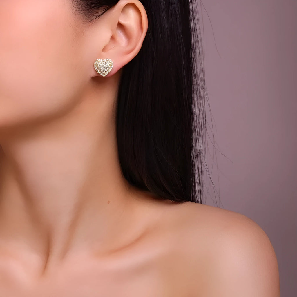 Heart-shaped moissanite stud earrings in gold-plated silver with minimalist design