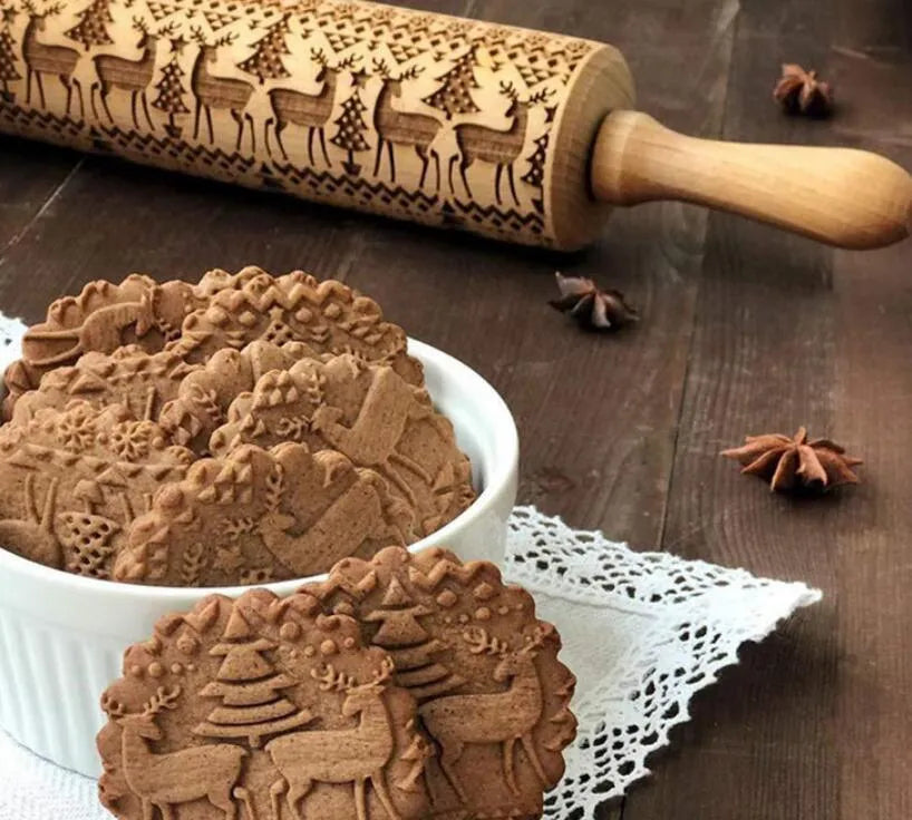 Wooden rolling pin with embossed Christmas patterns including reindeer and snowflakes on a 45cm length.