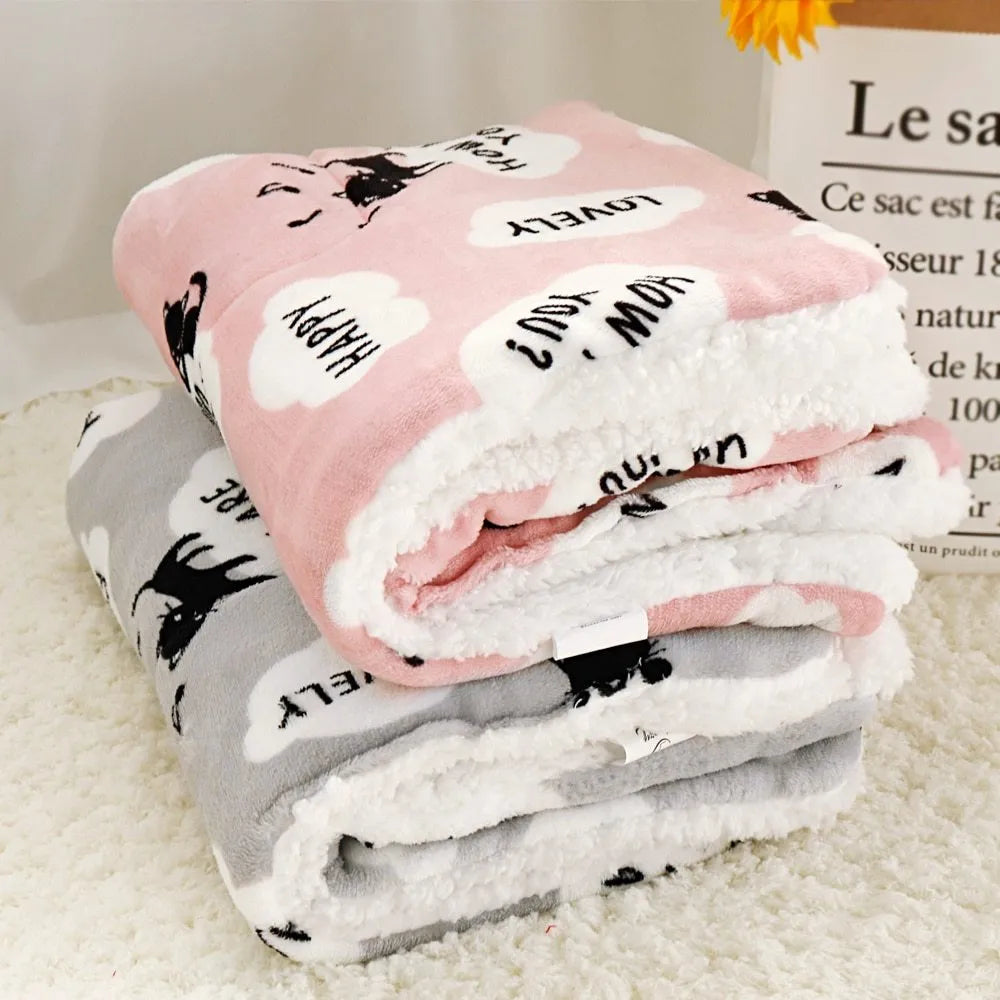 Lambskin pet blanket in flannel cashmere with cute cartoon pattern, grey colour, 55x70cm size on a pet bed
