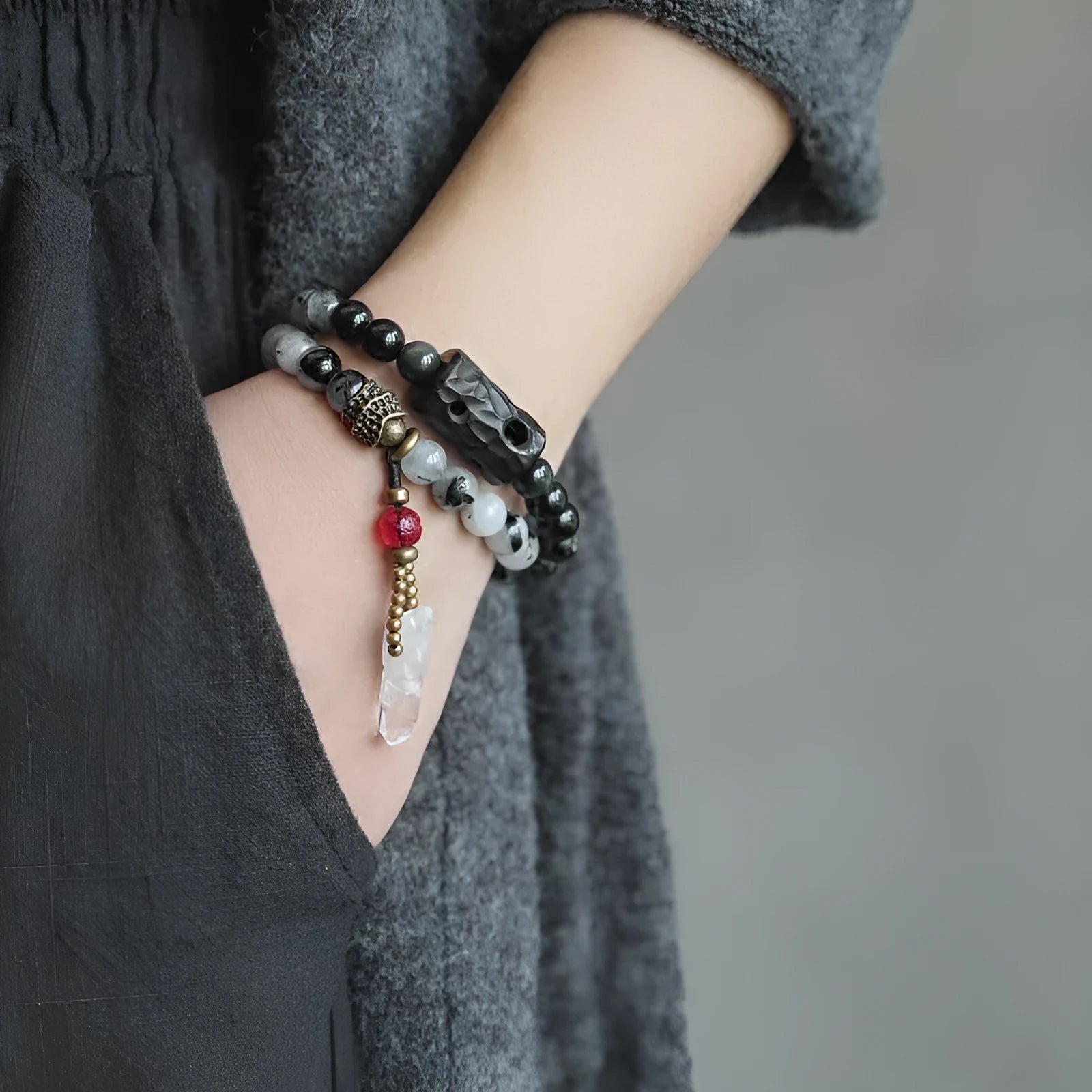 Men's black hair bracelet with white crystal tassel showing ethnic design and adjustable sizing